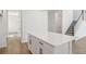Kitchen island with cabinets and drawers with quartz countertop, with a staircase and hallway in the background at 339 Conway Ave, St Cloud, FL 34771