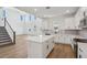 Bright open-concept kitchen with an island, and staircase and tall windows on the wall at 339 Conway Ave, St Cloud, FL 34771
