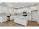 Bright, modern kitchen featuring white cabinetry, stainless steel appliances, and a center island with seating at 339 Conway Ave, St Cloud, FL 34771