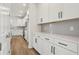 Well-lit kitchen with white cabinets, light countertops, stainless steel appliances, and light wood flooring at 339 Conway Ave, St Cloud, FL 34771