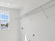 Bright laundry room with open shelving, window, and modern electric outlets at 339 Conway Ave, St Cloud, FL 34771