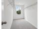 Walk-in closet featuring neutral carpet, a window, and metal shelving at 339 Conway Ave, St Cloud, FL 34771