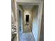 Long hallway with new doors and flooring at 3434 Avenue T Nw, Winter Haven, FL 33881