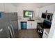 Renovated kitchen showcases modern appliances, white cabinetry, and a bright, functional layout at 911 Pine Ave, Mount Dora, FL 32757
