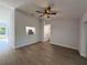 Spacious open-concept living room with durable wood-look flooring and recessed lighting at 911 Pine Ave, Mount Dora, FL 32757