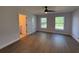 Main Bedroom boasts new wood-look floors, ceiling fan, en suite bathroom, and two bright windows at 911 Pine Ave, Mount Dora, FL 32757