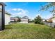 Expansive backyard with lush green grass, a black fence, and well-manicured landscaping at 9133 Smithies St, Orlando, FL 32827