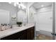 Well-lit bathroom featuring dual sinks, a full tub, and clean, neutral decor at 9133 Smithies St, Orlando, FL 32827