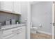 Convenient half bathroom with white cabinets and granite countertop at 9133 Smithies St, Orlando, FL 32827