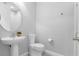 Powder room featuring a pedestal sink, modern toilet, and neutral walls at 9133 Smithies St, Orlando, FL 32827