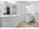 Bright bathroom with double vanity, framed mirror, tiled floor and closet for storage at 9133 Smithies St, Orlando, FL 32827