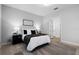 Neutral primary bedroom showcasing a cozy bed, soft rug, and an open doorway to the bathroom at 9133 Smithies St, Orlando, FL 32827