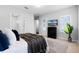 Bright and spacious bedroom with a decorative plant, large windows, and a door leading to the bathroom at 9133 Smithies St, Orlando, FL 32827
