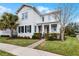 Two-story house with white exterior, black shutters, and a landscaped lawn at 9133 Smithies St, Orlando, FL 32827