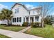 Charming two-story home with a well-manicured lawn, and covered front porch at 9133 Smithies St, Orlando, FL 32827