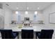 Bright, modern kitchen with a large island, barstool seating, and pendant lighting at 9133 Smithies St, Orlando, FL 32827