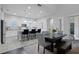 Bright kitchen and dining area featuring a spacious island, white cabinetry, and modern appliances at 9133 Smithies St, Orlando, FL 32827