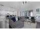 Bright and airy living room with open-concept kitchen, high ceiling, comfortable seating, and hardwood floors at 9133 Smithies St, Orlando, FL 32827