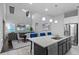 Bright and airy living room with open-concept kitchen, high ceiling, comfortable seating, and hardwood floors at 9133 Smithies St, Orlando, FL 32827