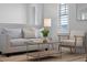 A cozy living room setup with a comfortable sofa, chair, and modern coffee table on a jute rug at 9133 Smithies St, Orlando, FL 32827