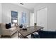 Office featuring a wooden desk, comfortable seating and natural light from window with shutters at 9133 Smithies St, Orlando, FL 32827