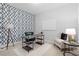 Stylish office with patterned accent wall, wooden desk, and comfortable seating at 9133 Smithies St, Orlando, FL 32827
