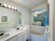 Bathroom with double vanity and bathtub at 147 Dahlia Village Cir # Ge, Orlando, FL 32807