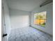 Bright bedroom with tile floors and backyard view at 147 Dahlia Village Cir # Ge, Orlando, FL 32807