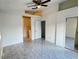 Primary bedroom with tile floors and mirrored closet doors at 147 Dahlia Village Cir # Ge, Orlando, FL 32807