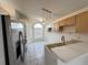 Kitchen with stainless steel appliances and light wood cabinets at 147 Dahlia Village Cir # Ge, Orlando, FL 32807