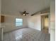 Spacious living room featuring tile floors and a ceiling fan at 147 Dahlia Village Cir # Ge, Orlando, FL 32807