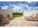 Private backyard patio with brick pavers, lounge chairs, and small table at 5149 Adelaide Dr, Kissimmee, FL 34746