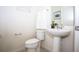 Pedestal sink, toilet, and updated fixtures at 5149 Adelaide Dr, Kissimmee, FL 34746