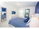 Spacious bedroom with a blue accent wall and patterned bedding at 5149 Adelaide Dr, Kissimmee, FL 34746