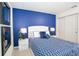 Bedroom with blue walls and patterned bedding at 5149 Adelaide Dr, Kissimmee, FL 34746