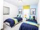 Twin-size beds, nightstand, and cheerful decor at 5149 Adelaide Dr, Kissimmee, FL 34746
