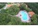 Aerial view of community pool with many swimmers and surrounding landscape at 5149 Adelaide Dr, Kissimmee, FL 34746