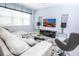 Bright living room featuring comfortable seating and large TV at 5149 Adelaide Dr, Kissimmee, FL 34746