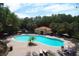 Community pool with lounge chairs and a pool house at 5149 Adelaide Dr, Kissimmee, FL 34746