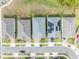 An aerial view showcases rooftops, highlighting homes with solar panels in a well-planned community at 7409 Wing Span Way, Harmony, FL 34773