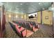 Home cinema with red reclining seats and a large screen showcasing the 