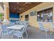 Relaxing outdoor seating area with blue chairs and tables next to the pool and bar at 8939 Bismarck Palm Rd, Kissimmee, FL 34747