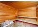 Cozy sauna room with wooden benches, paneled walls, and a traditional heater for relaxation at 8939 Bismarck Palm Rd, Kissimmee, FL 34747