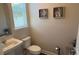 Clean and simple half bathroom with a pedestal sink at 9271 Patrimonio Loop, Windermere, FL 34786