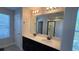 Double vanity bathroom with a large mirror and a walk-in shower at 9271 Patrimonio Loop, Windermere, FL 34786