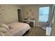 Bright bedroom with a bed, desk, and window at 9271 Patrimonio Loop, Windermere, FL 34786