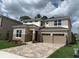 Two-story home with a two-car garage and a beautiful brick driveway and front lawn at 9271 Patrimonio Loop, Windermere, FL 34786