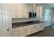 White kitchen cabinets, granite countertops and stainless steel appliances at 9271 Patrimonio Loop, Windermere, FL 34786
