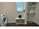Laundry room features washer, dryer, shelving and shoe storage at 9271 Patrimonio Loop, Windermere, FL 34786