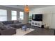 Relaxing living room featuring a sectional sofa and large TV at 9271 Patrimonio Loop, Windermere, FL 34786